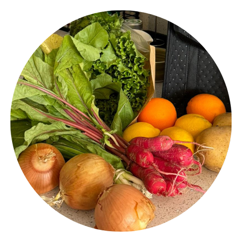 Weekly harvest of fresh vegetables and fruits from Florida farms, featuring lettuce, onions, radishes, potatoes and citrus