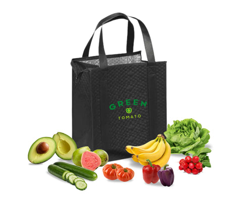 Reusable Green Tomato delivery bag filled with fresh fruits and vegetables including avocado, guava, bananas, lettuce, cucumber, tomatoes, bell peppers, and radishes